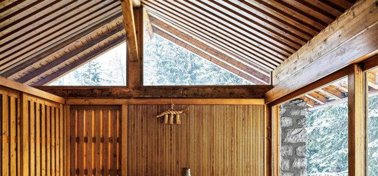 spare wood paneled room with simple dining table and chairs at center